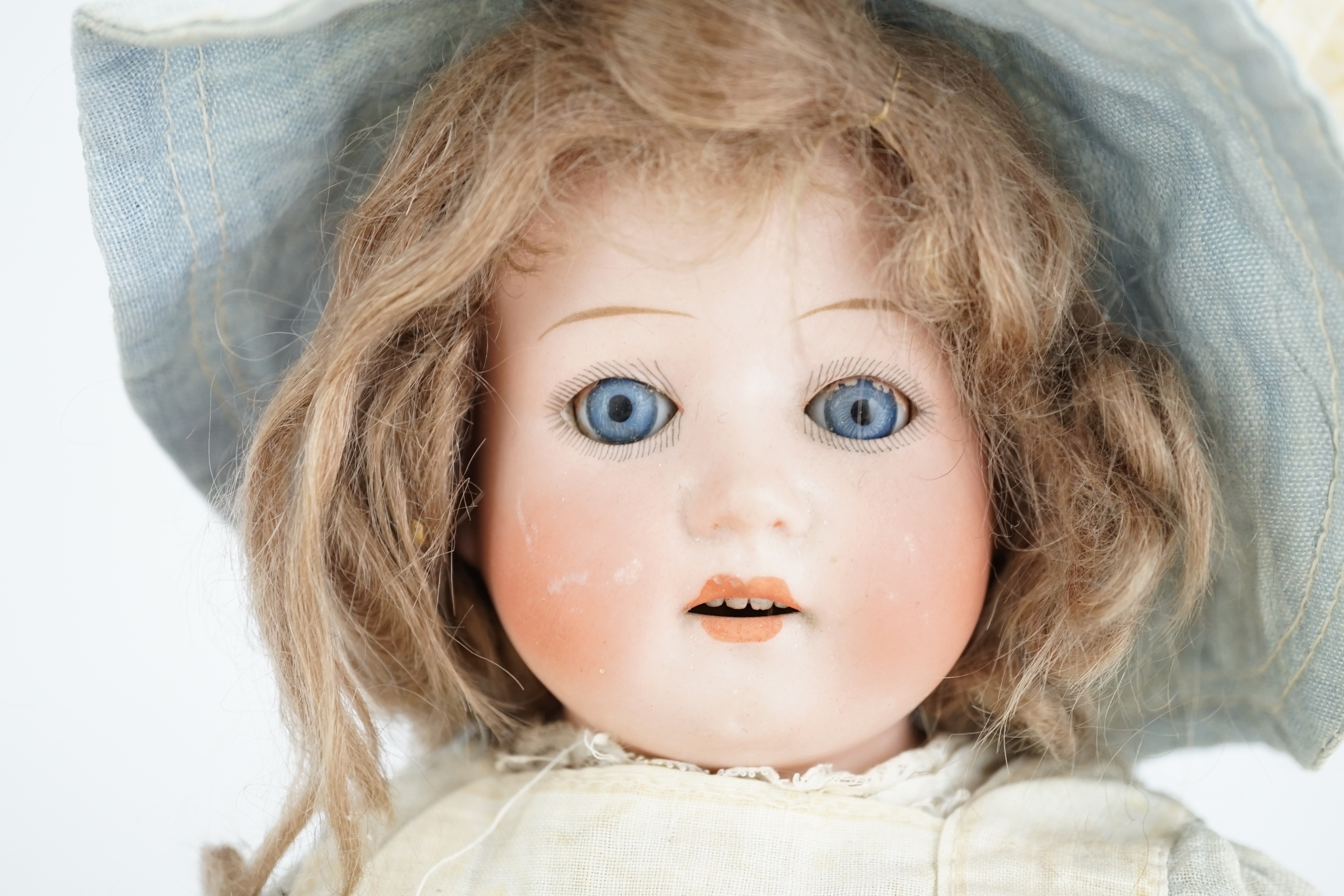 An AM390, 46cm, a Heubach shoulder plate, 34cm, together with wooden doll, 30cm